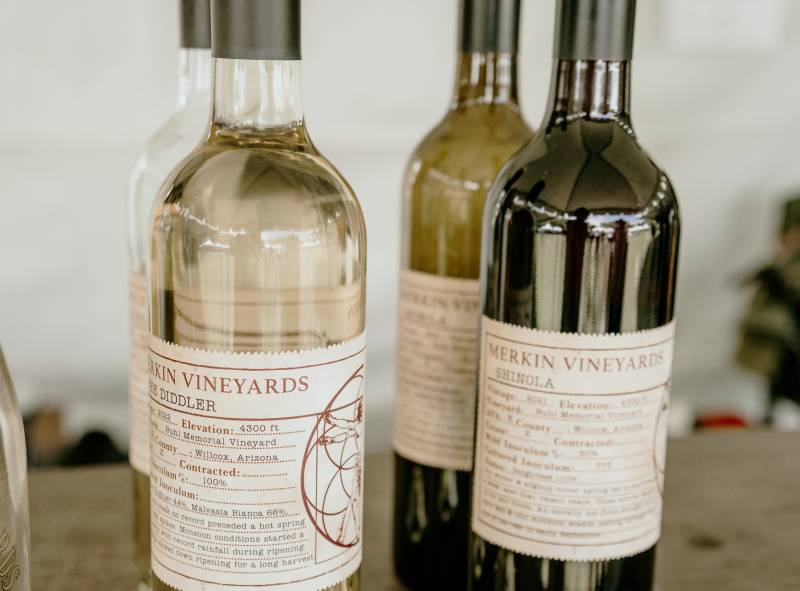 Bottles of white and red wine sit on a table at Sedona WineFest.